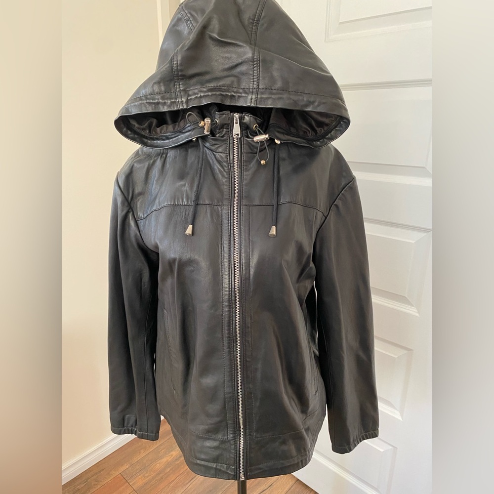 Tag still on. Never worn.Danier Black Leather Hooded Jacket